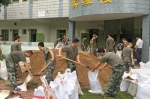 ⑤西阳镇抢险队员在装填沙袋准备防洪。（高讯 摄） - Meizhou.Cn