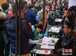 资料图：在武汉市纳杰人才市场招聘会上，挤满了前来应聘的求职者。中新社记者 张畅 摄 - 新浪广东