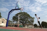 小男孩在詹厝村崭新的篮球场打篮球。他的脚下原是一大片违建。 - 新浪广东